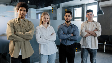 Happy proud professional group diverse business people stand in office with their arms crossed smile confidently looking at camera successful corporate team young employees company posing workspace