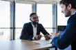 © Westend61 - Smiling client talking to businessman in office