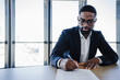 © Westend61 - Client signing house contract with pen in office