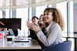 © Westend61 - Cheerful business colleagues applauding in meeting at coworking office