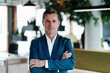 © Westend61 - Serious businessman with arms crossed at office