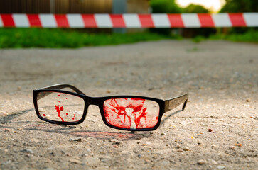 glasses in blood bullet hole. crime scene, murder in the head