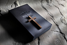 Praying With Wooden Crucifix Cross On Holy Bible Background