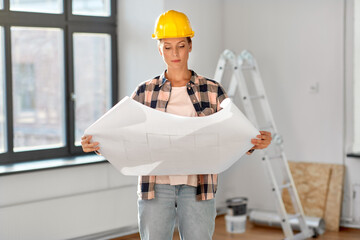 Poster - repair, building and real estate concept - woman in helmet with blueprint sitting on floor at home