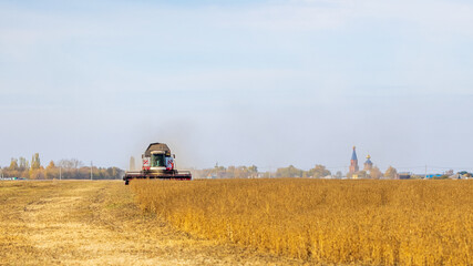 Wall Mural - Combine Harvester Working on a Field. Seasonal Harvesting the Wheat, Soy. Agriculture. Farm. Crop. Agrarian business. Industry 