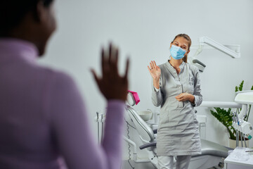 Wall Mural - Patient waving to dentist while leaving