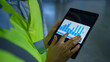 © stockbusters - Factory workers analizing graphs checking data on tablet screen hands closeup
