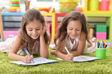 Canvas Print - Two cute little girls drawing with pencils