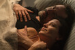© Halfpoint - Sad mature man feeling guilty, thinking about cheating his wife, while his wife is snuggling to him.