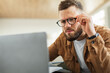 © Prostock-studio - Man Looking At Laptop Squinting Eyes Wearing Eyeglasses Indoor