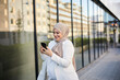 © Johnér - Smiling woman using cell phone