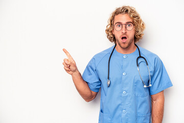 Wall Mural - Young nurse caucasian man isolated on white background pointing to the side