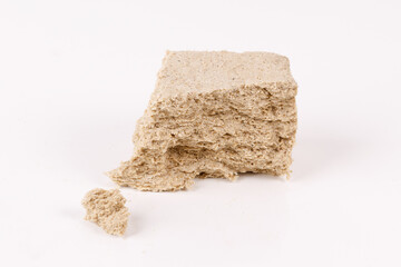 Poster - halva with crumbs on white background