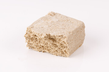 Poster - halva with crumbs on white background