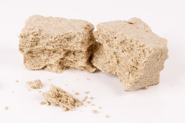 Poster - halva with crumbs on white background