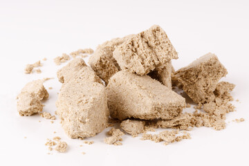 Poster - a large pile of halva with crumbs on a white background