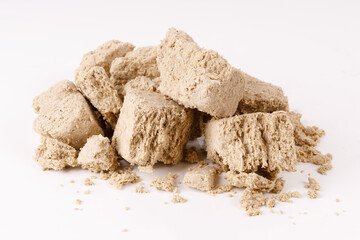 Poster - a large pile of halva with crumbs on a white background