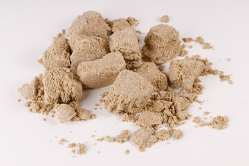 Poster - a large pile of halva with crumbs on a white background
