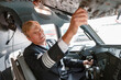 © Kostiantyn - Aircraft pilot checking overhead panel before the flight