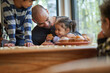 © Trevor Adeline/Caia Image - Happy father and daughter eating muffin at dining table
