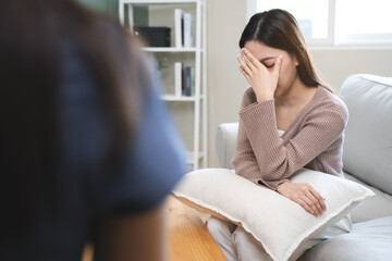 Young woman in a mental therapy session talking with a psychologist in the office.