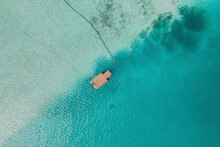 Aerial Top Down View Of A Floating House Surrounded By Clear Blue Ocean In South Male Atoll, Maldives.