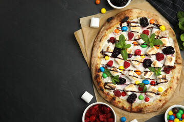 Wall Mural - Tasty sweet pizza and ingredients on black table, flat lay. Space for text