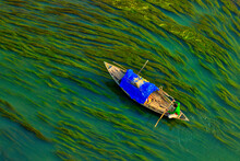 Aerial View Of A Person Sailing With A Canoe In The River With Algae, Sirajganj, Bangladesh.