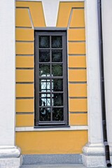 Wall Mural - one long brown window on the concrete wall of a building with white columns outside