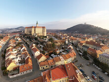 Aerial view of Zamek Mikulov castle with residential district in foreground in wintertime with snow in Mikulov, Czech Republic.