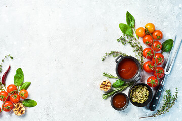 Wall Mural - Gray stone cooking background. Spices and vegetables. Top view. Free space for your text.