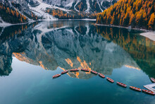 Aerial View Of Boats Anchored Along The Lago Di Braies Lake, Dolomites, Italy.