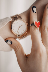 Wall Mural - Elegant classic stylish white watch on woman hand. Close up photo.