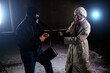Girl strikes robber with bat. Self defense concept