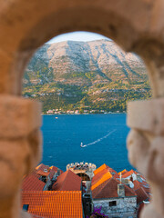 Wall Mural - Windsurfer windsurfing at Korcula Town at sunset, seen from St Marks Cathedral bell tower, Korcula Island, Dalmatia (Dalmacija), Croatia