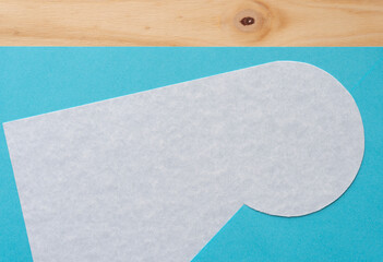 abstract paper shape on blue paper and wood