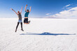 © Matthew - Young tourist couple on vacation while traveling on a gap year, experiencing the amazing, unique landscape of Uyuni Salt Flats (Salar de Uyuni), Uyuni, Bolivia, South America