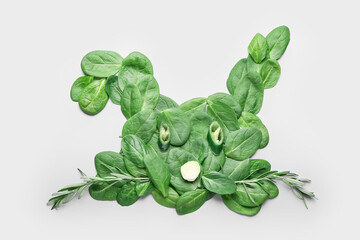 Rabbit made of green vegetables on light background