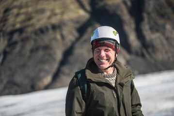 Wall Mural - Portrait of a happy old man on vacation on an adventure holiday on Breidamerkurjokull Glacier, Vatnajokull Ice Cap, Iceland, Europe