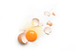 © Paitoon - Flat lay of splattered broken egg on white background.