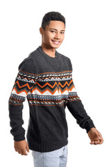 Wall Mural - Handsome African-American guy in knitted sweater on white background