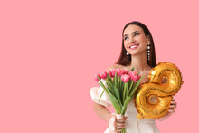 Stylish Young Woman With Tulips And Balloon In Shape Of Figure 8 On Pink Background. International Women's Day
