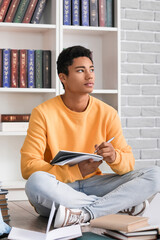 Sticker - Male African-American student studying in library