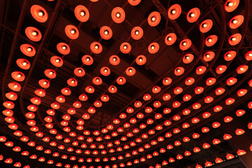 Poster -  light bulb mounted on industrial style ceiling. Modern building interior abstract background