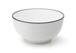 Empty white ceramic bowl with black rim