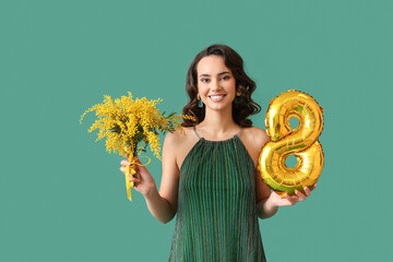 Wall Mural - Smiling young woman with mimosa flowers and balloon in shape of figure 8 on green background. International Women's Day