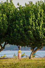 Wall Mural - Woman Selling Ikat Weavings on the Beach at Kuta Lombok, South Lombok, Indonesia, Asia