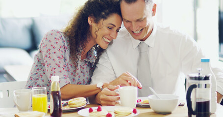 Sticker - Love turns the day on. Shot of an affectionate middle aged couple having breakfast together in the morning at home.