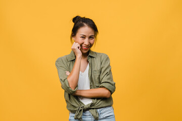 Wall Mural - Portrait of young Asia lady with positive expression, arms crossed, smile broadly, dressed in casual clothing and looking at camera over yellow background. Happy adorable glad woman rejoices success.