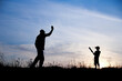 © Kostia - silhouette of father and son playing baseball on nature family sport